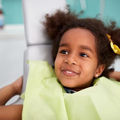 Young girl smiling dental chair for their first visit
