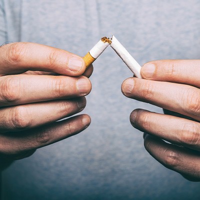 Man breaking a cigarette