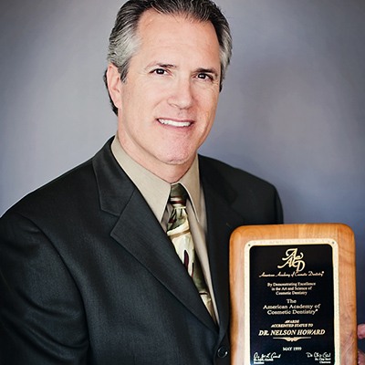 Doctor Howard holding a plaque