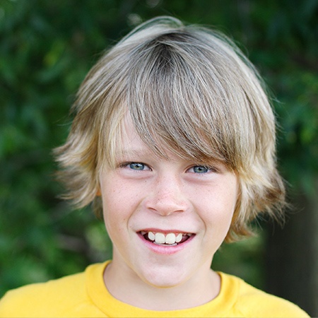 Young boy with healthy smile after children's dentistry