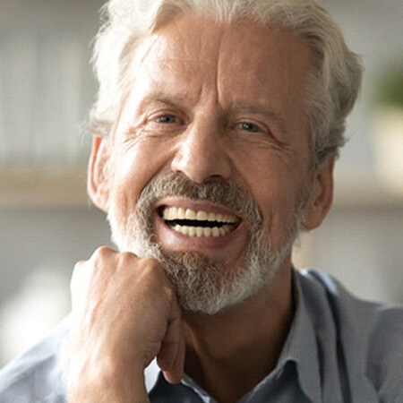 closeup of man smiling after getting dentures
