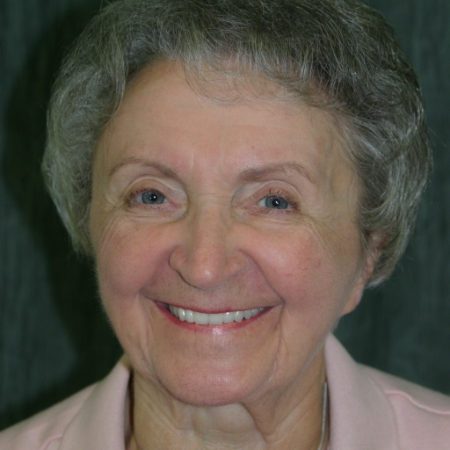 older woman smiling while visiting dentist