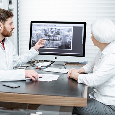 Implant dentist in Rancho Bernardo showing patient an X-ray