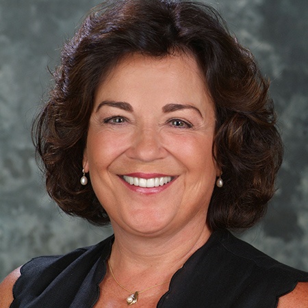 Woman smiling after getting dental implants in Rancho Bernardo