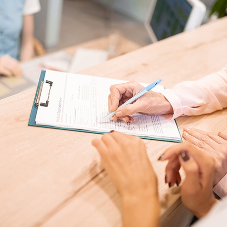 Patient filling out dental insurance forms