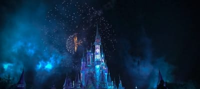 Disney World castle surrounded by fireworks