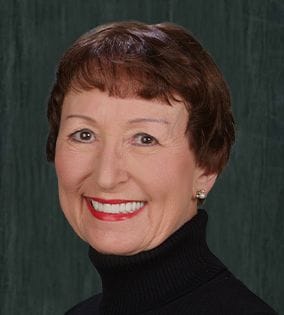 Woman with short brown hair smiling