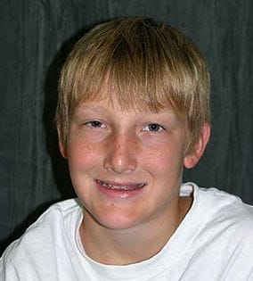 Young man with blond hair smiling