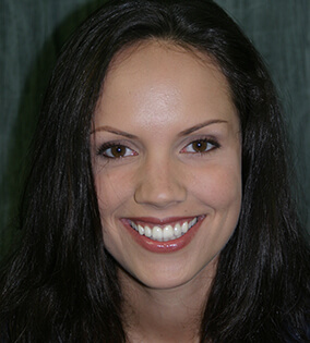 Young woman with long dark hair smiling