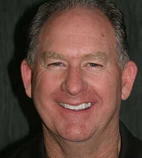 Man in black shirt smiling