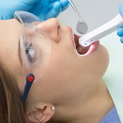 Dentist using intraoral camera to capture smile images