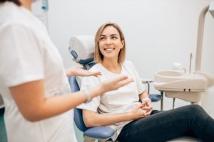 smiling woman talking to her dentist 
