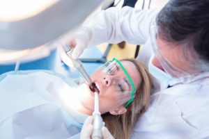 dentist performing full mouth reconstruction on a patient 