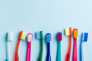 different types of toothbrushes laid out in a row