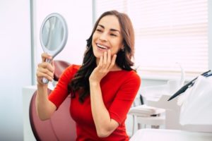 a patient inspecting their smile in a mirror