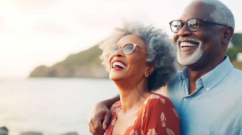 Senior couple smiles at lake