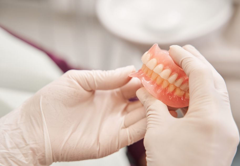 Dentist holding dentures